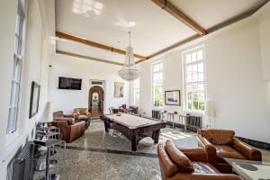 a living room with a pool table and couches at Leverhulme Hotel in Port Sunlight