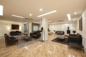 a large living room with couches and chairs at Hotel Monte Meraviglia in Cascia