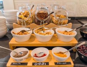 a buffet with bowls of different types of food at Catalonia Donosti in Donostia-San Sebastián