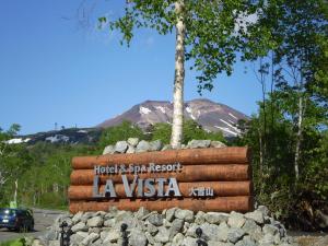 a sign for la usa with a mountain in the background at La Vista Daisetsuzan in Higashikawa