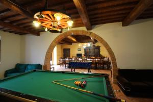 a pool table in a living room with an arch at Casa Bella in Torrita di Siena