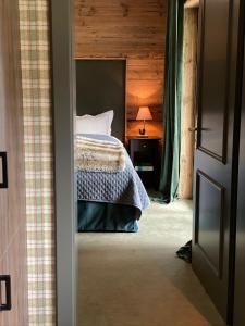 a bedroom with a bed and a table with a lamp at Chalet Bull Zermatt in Zermatt