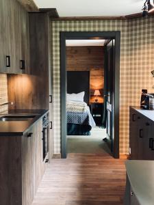 a kitchen with a bedroom with a bed in it at Chalet Bull Zermatt in Zermatt