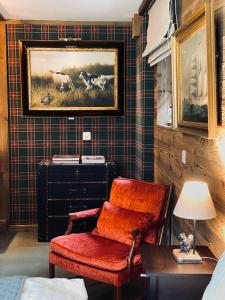 a room with a chair and a painting on the wall at Chalet Bull Zermatt in Zermatt