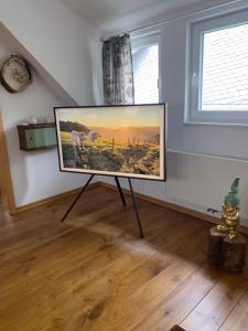 a flat screen tv on a stand in a room at Traumferienhaus Sauerland in Schmallenberg
