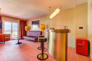 una habitación de hotel con un bar en el centro de la habitación en Romeos Ibiza - Adults Only en San Antonio Bay