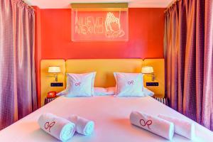 a bedroom with a bed with two towels on it at Romeos Ibiza - Adults Only in San Antonio Bay