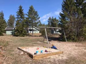 a child is playing in a sandbox in a park at Marbyfjärden seaside village Lyckan in Eckerö