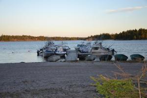 a group of boats are docked in the water at Marbyfjärden seaside village Lyckan in Eckerö +2 photos