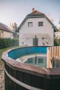 a swimming pool in front of a house at Csónakos ház / The boat house in Badacsonyörs