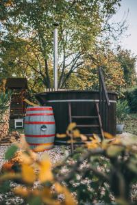 a barrel sitting on the ground next to a playground at Csónakos ház / The boat house in Badacsonyörs