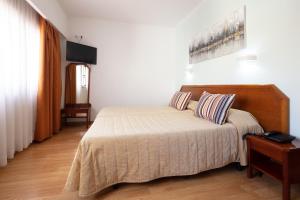 Postel nebo postele na pokoji v ubytování Hotel Anjos