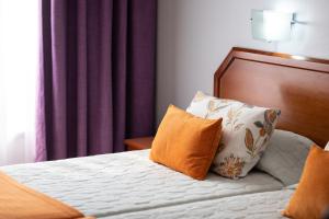 Postel nebo postele na pokoji v ubytování Hotel Anjos