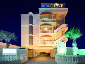 a hotel with a lit up facade at night at Hotel Fine Olive Sakai in Sakai