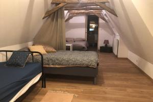 ein Schlafzimmer mit 2 Betten und ein Dachgeschoss in der Unterkunft Chez Rénou et Prospérou maison typique du Sarladait in Genestal