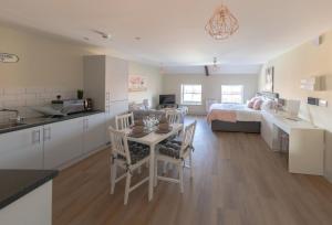 eine Küche und ein Wohnzimmer mit einem Bett und einem Tisch in der Unterkunft Apartment 9, Isabella House, Aparthotel, By RentMyHouse in Hereford