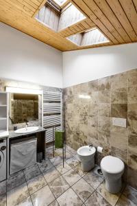 a bathroom with two sinks and a toilet at Faber Apartments-Residence Style in Arona