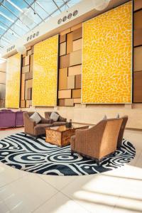 a lobby with couches and a rug at Traders Hotel, Abu Dhabi in Abu Dhabi