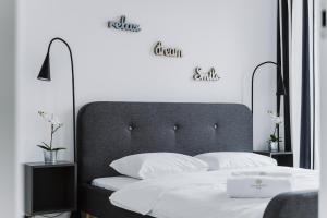 a bedroom with a large bed with two pillows at Apartment4You Select Kolejowa in Warsaw