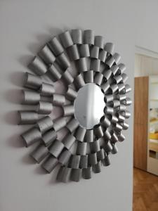 a metal wall art with a mirror on a wall at Spiegel Center in Oradea