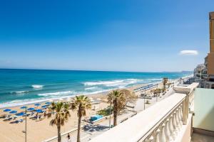 a view of a beach with palm trees and the ocean at Birais Beach Studios in Rethymno