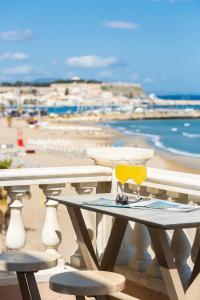 a table on a balcony with a view of the beach at Birais Beach Studios in Rethymno