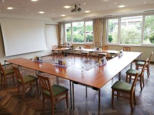 a large room with a large table and chairs at Hotel Happinger Hof in Rosenheim