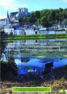 a flyer with two chairs and a table in front of a town at Passage du Saumon in Montrichard