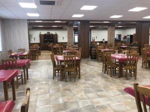 a dining room with wooden tables and chairs at Area de Servicio los Cerrillos, H-CC-651 in Peraleda de la Mata +13 photos