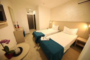 Postel nebo postele na pokoji v ubytování Hotel Delfin