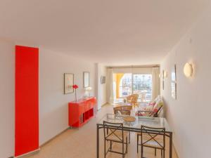 a living room with a red cabinet and a table at Apartment Bahia II by Interhome in Empuriabrava