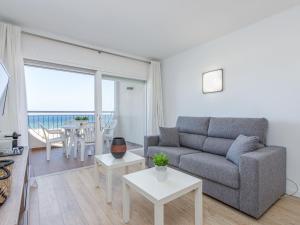 a living room with a couch and a table at Apartment Bahia I by Interhome in Empuriabrava