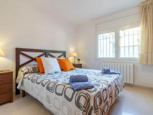 a bedroom with a large bed with two towels on it at Holiday Home Requesens by Interhome in Empuriabrava