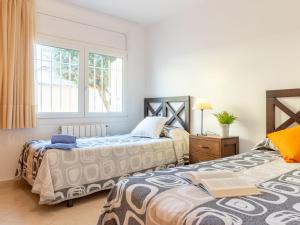 two beds sitting next to each other in a room at Holiday Home Requesens by Interhome in Empuriabrava