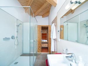 a bathroom with a glass shower and a sink at Apartment Am Bärenkopf-2 by Interhome in Maurach