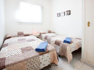 a room with two beds and a window at Holiday Home D'Ibis by Interhome in Empuriabrava +21 photos