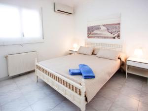 a bedroom with a large bed and a desk at Holiday Home D'Ibis by Interhome in Empuriabrava