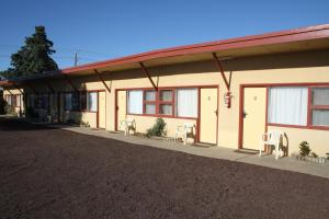 a building with doors and chairs in front of it at Nhill Oasis Motel in Nhill