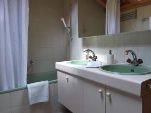 La salle de bains est pourvue de 2 lavabos et d'une douche. dans l'établissement Apartment Stöckli by Interhome, à Lenk im Simmental