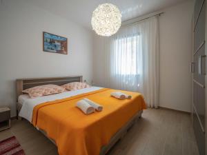 a bedroom with a bed with two towels on it at Apartment Judita by Interhome in Jadranovo