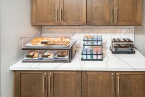 a kitchen with a counter with bread and other foods at Staybridge Suites Florence - Cincinnati South, an IHG Hotel in Florence