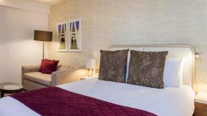 a hotel room with a bed and a couch at Crowne Plaza London Kings Cross, an IHG Hotel in London