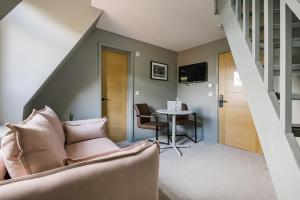 a living room with a couch and a table at CitySpace Tower Bridge in London