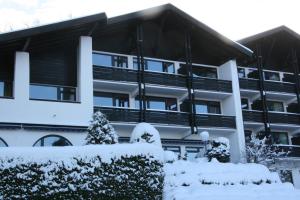 a person standing on top of a snow covered building at Hotel Schloss Berg in Berg am Starnberger See