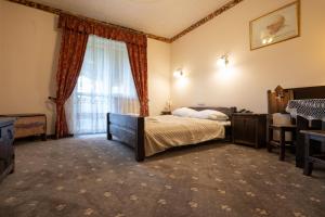 Postel nebo postele na pokoji v ubytování Hotel Trylogia