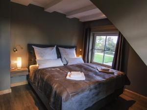 a bedroom with a bed with two towels on it at Ferienhaus Gut Glück in Lancken-Granitz