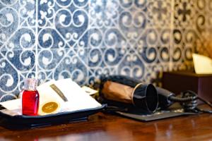 a table with a bag and a bottle of lipstick at Montree Phuket Hotel in Phuket Town