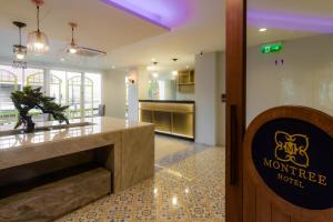 a lobby with a sign for a morgue at Montree Phuket Hotel in Phuket Town