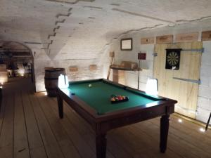 a pool table in the middle of a room at Bed & Breakfast Chateau Les Cèdres in Bretteville-lʼOrgueilleuse