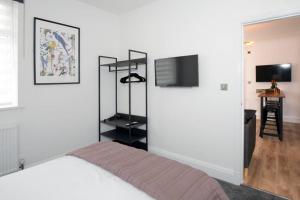 a bedroom with a bed and a flat screen tv at Blackbird Luxury Accommodation Room 10 in Blackpool